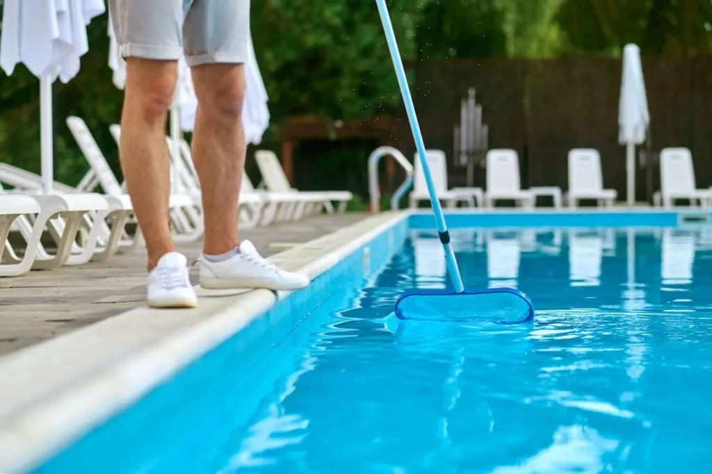 a service person cleaning the swimming pool and lo 2023 11 27 05 23 43 utc 4 11zon